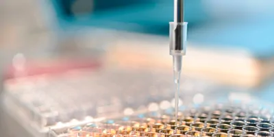 Scientists studying peptide samples in laboratory